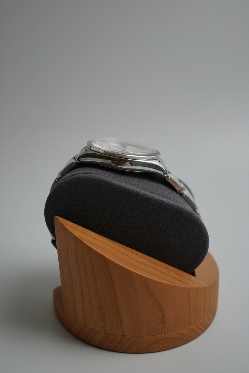 Watch on a wooden stand with a blurred outdoor background